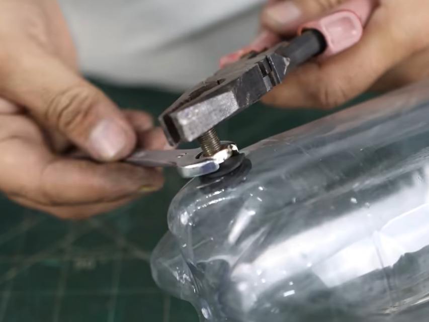Attaching bike valve to bottle with adhesive.