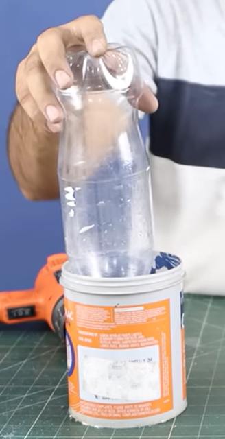 Cooling PVC joint in water to set around bottle cap.