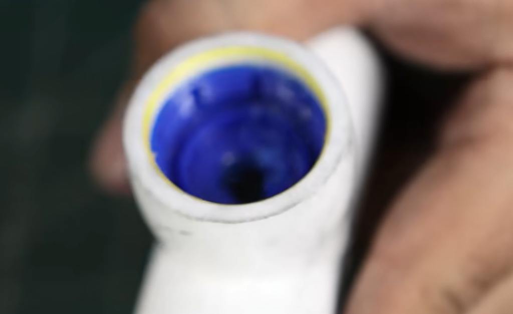 Drilling hole in bottle cap for water flow.