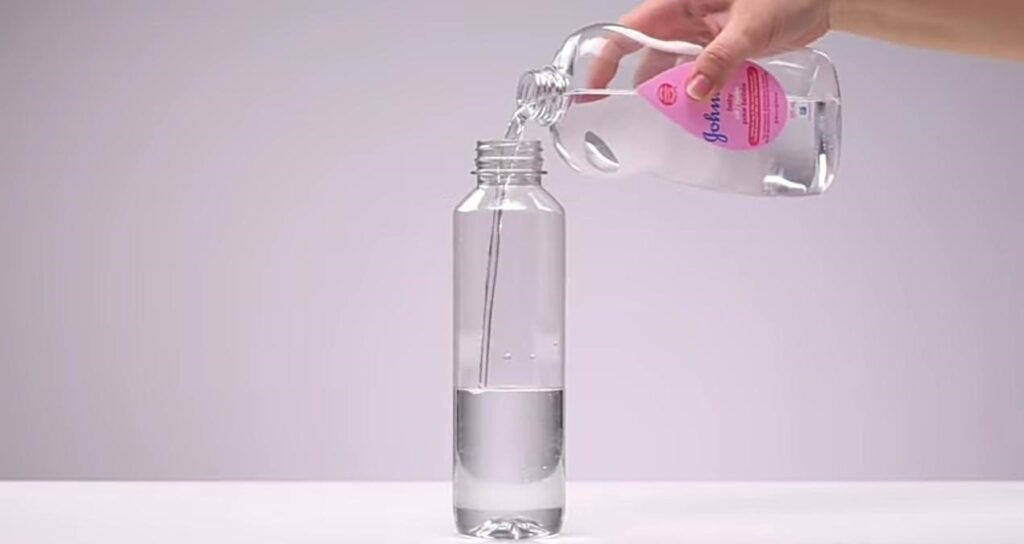 Pour Johnson's Baby Oil into an empty bottle