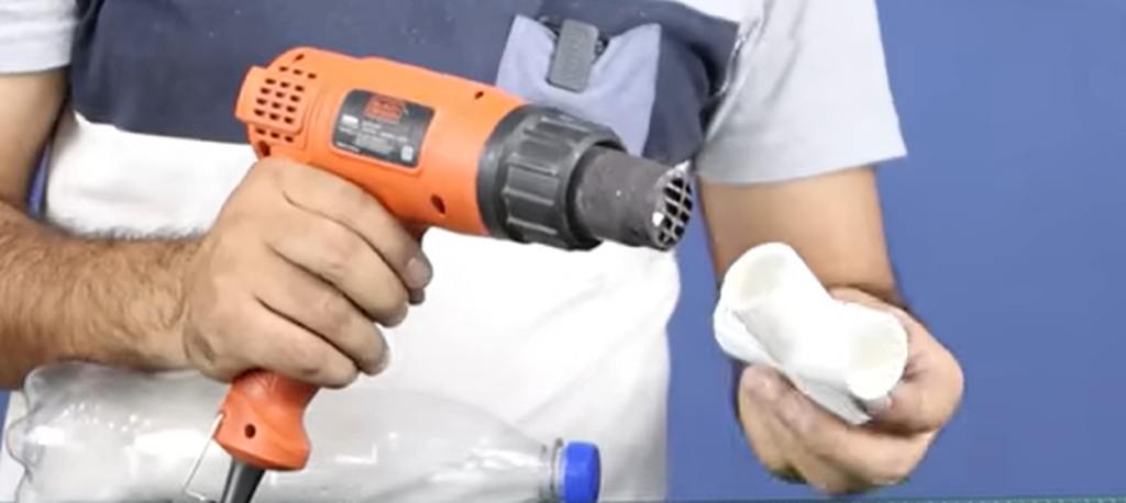 Softening PVC joint with heat to insert bottle cap.